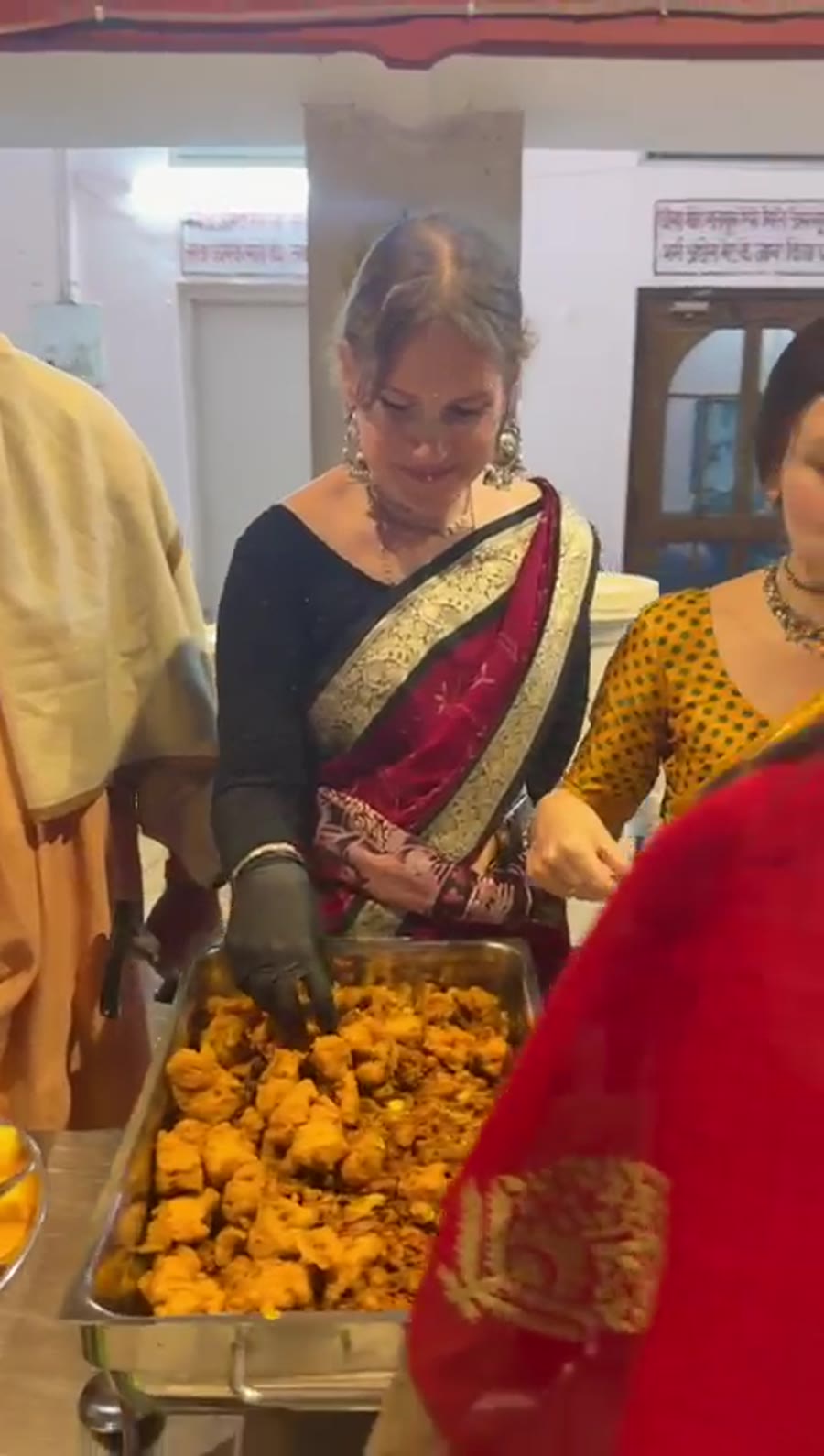 Volunteers serving hot vegetarian meals