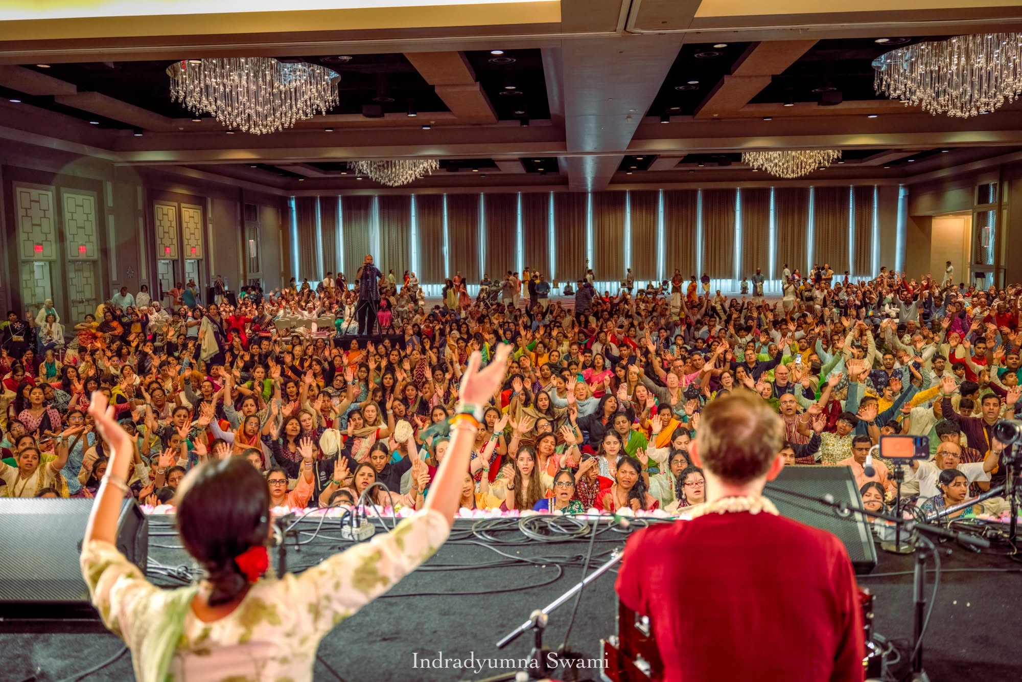 Crowd immersed in live kirtan music